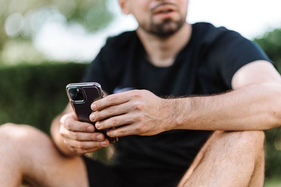 A person sitting down holding a cell phone

AI-generated content may be incorrect.